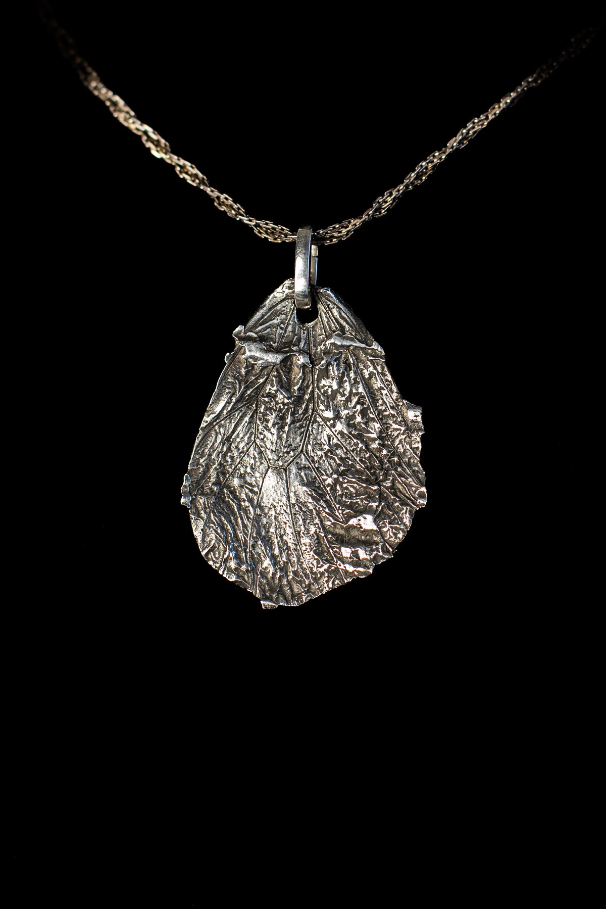 Idea Butterfly Fossil Pendant by HAFT on a chain, example of the pendant setting